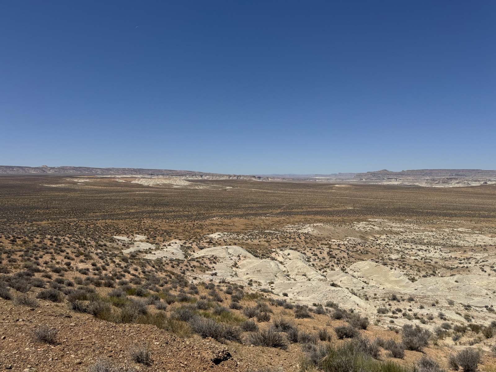 Wide high-desert plateau under a deep blue sky